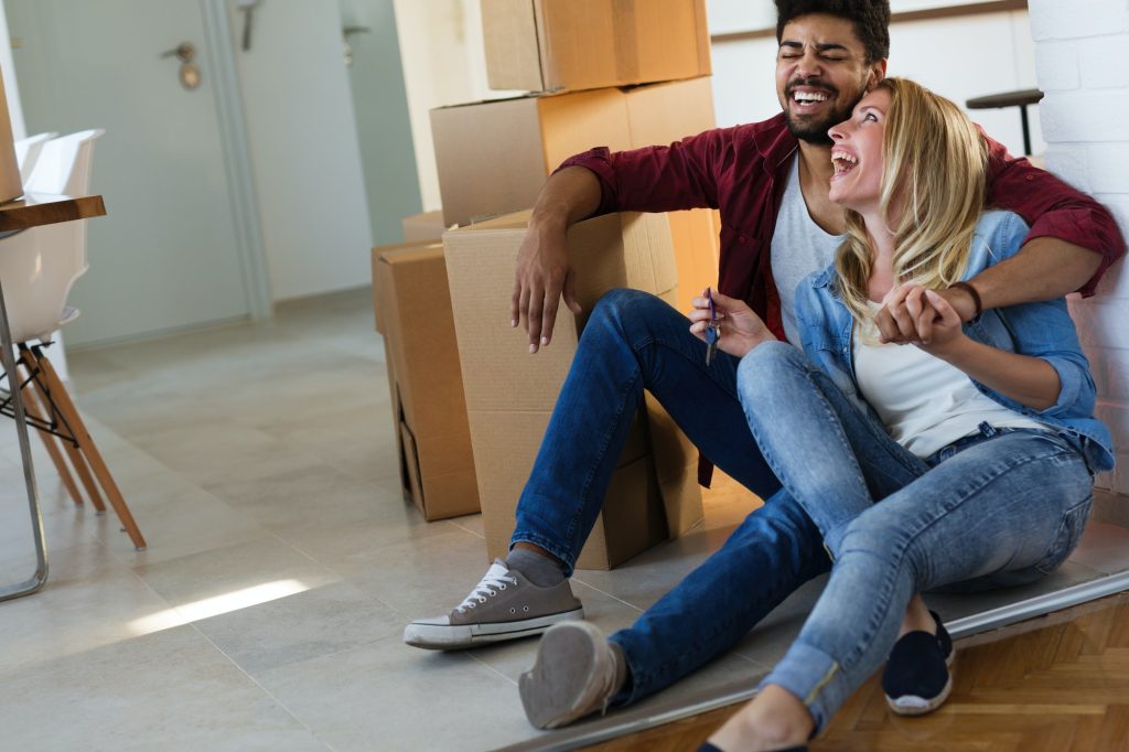 home, people, moving and real estate concept - couple in love moving in