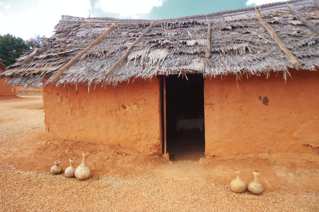 Traditional clay hut with thatched roof in West African Farm exhibit at Frontier Culture Museum