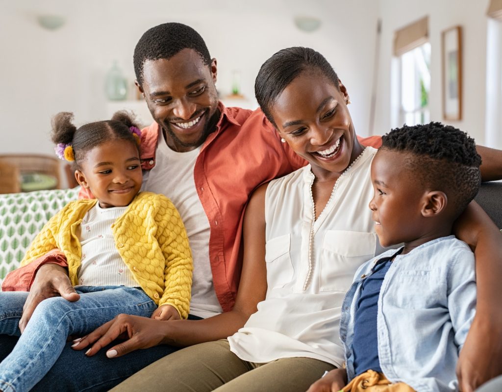Happy black family playing together at home