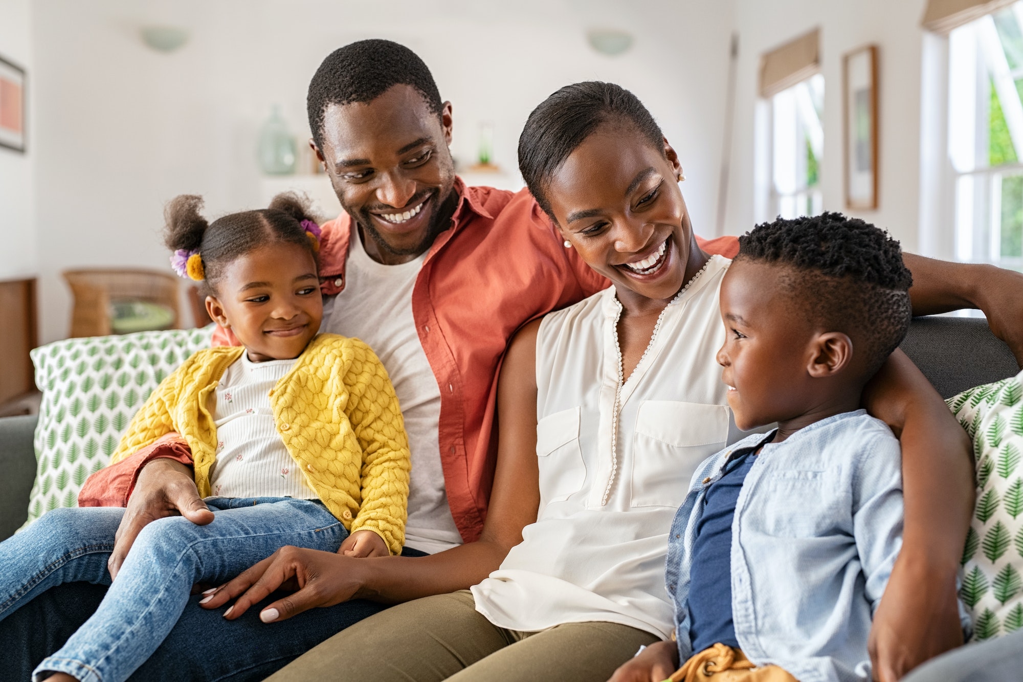 Happy black family playing together at home