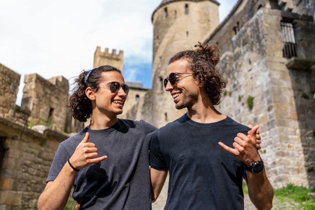 Friends embracing while gesturing to be cool in a medieval castle