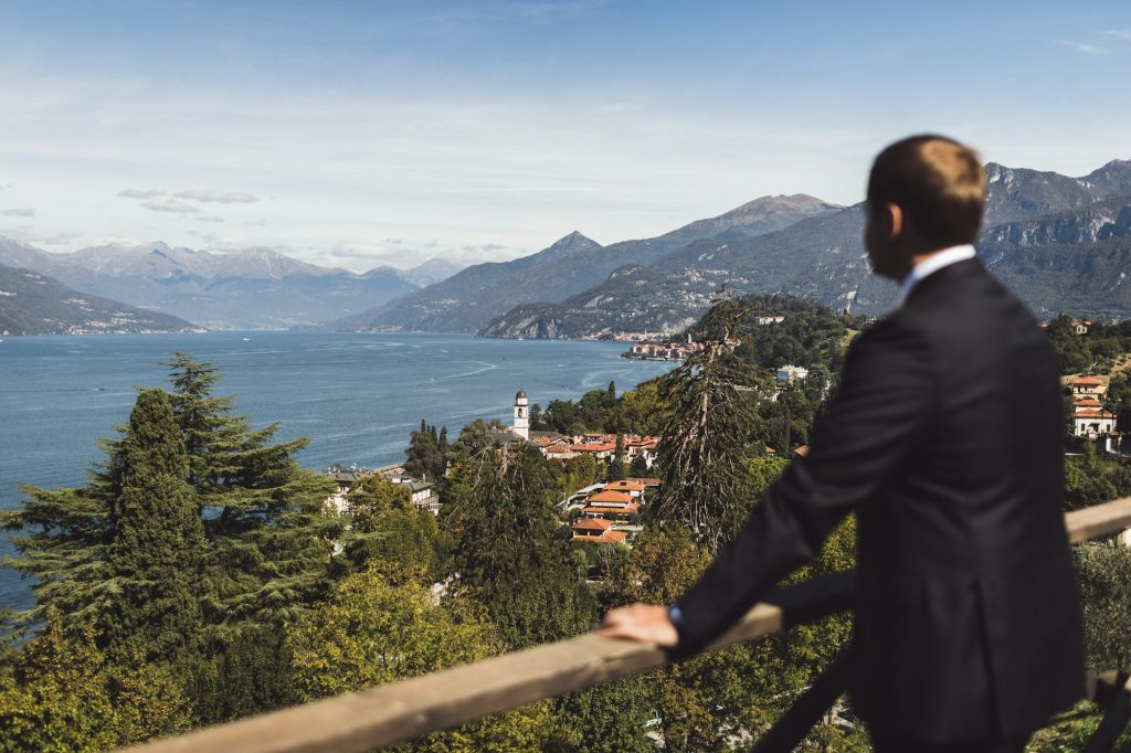 Man watching on Como lake mountain view. Bellagio town aerial view. Luxury and rich life concept