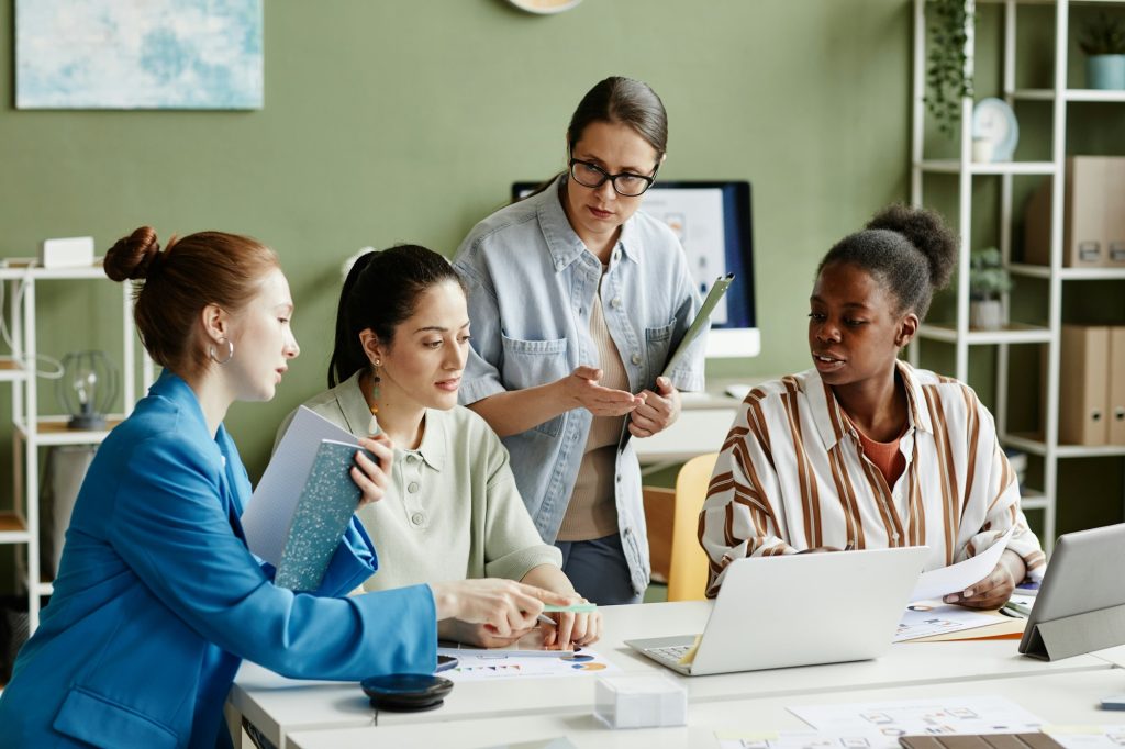 Business team using laptop at meeting